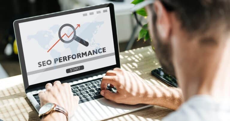 Man looks at a laptop with the words SEO on the screen