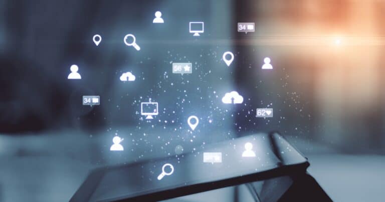 An image of a tablet on a desk with an overlaid graphic using various icons to depict online activities.