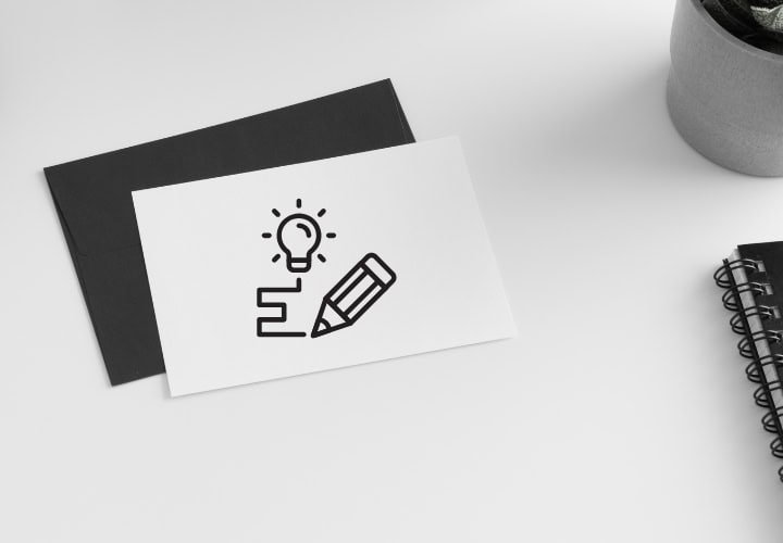 White business card on a desk with a graphic element representing branding